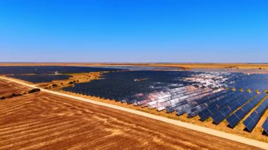Huge solar station across farmland. Expansive farmland covered with solar panels for renewable energy production.