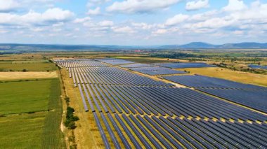 Massive solar power station view. Endless solar panels spread across the fields to generate green energy.