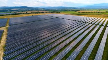 Rows of solar panels absorbing sunlight. Geometric installation of solar panels producing clean renewable energy.
