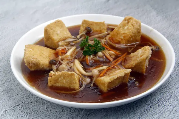 Photo of freshly cooked Chinese food Tofu with mushroom in oyster sauce.