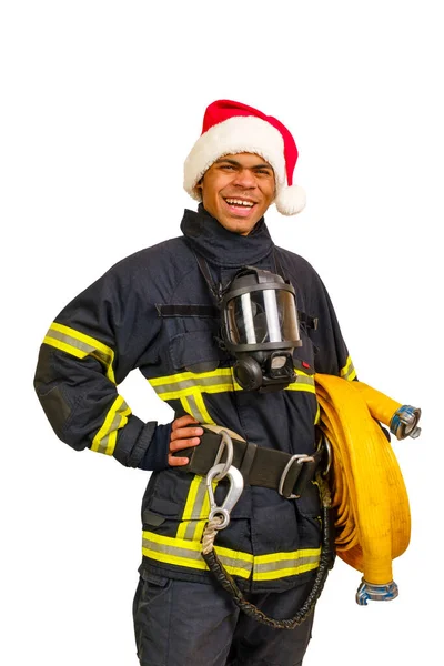 Jonge Lachende Afro Amerikaanse Brandweerman Uniform Rood Santa Hat Houdt Rechtenvrije Stockafbeeldingen
