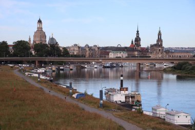 DRESDEN, GERMANY - JULY 06, 2024: view from elbe riverbank over carola bridge towards old city. High quality photo clipart