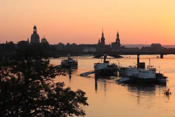 stock image DRESDEN, GERMANY - SEPTEMPER 18, 2024: Dresden city skyline with partially collapsed Carola bridge flooded at sunset from Albert bridge. High quality photo