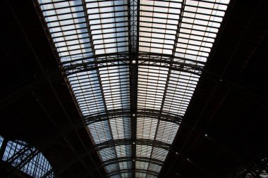LEIPZIG, GERMANY - AUGUST 19, 2018: Interior view of the vaulted glass roof structure inside Leipzig Central Station, highlighting industrial design and architecture. High quality photo
