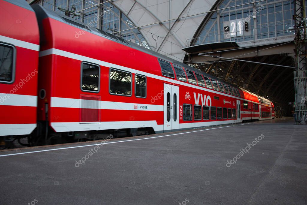LEIPZIG, GERMANY - AUGUST 19, 2018: Regional double-decker train at platform inside Leipzig main station during daytime. High quality photo