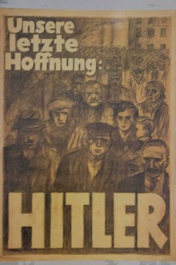 DACHAU, GERMANY - NOVEMBER 25, 2017: Historical Nazi propaganda poster with the slogan Unsere letzte Hoffnung: Hitler displayed at the Dachau concentration camp memorial exhibition. High quality