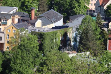WASSERBURG AM Hanı, GERMANY - 2 Mayıs 2025: Wasserburg am Inn 'in tarihi çatıları ve kıvrımlı sarmaşık kaplı yeşil yerleşim alanının havadan görünüşü. Yüksek kalite fotoğraf