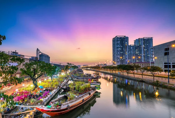 stock image Ho Chi Minh City, Vietnam - January 31st, 2022: Flowers boat at market along canal wharf. This place Farmers sell apricot blossom and other flowers on Lunar New Year in Ho Chi Minh city, Vietnam