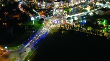 Aerial view of Da Lat city night beautiful tourism destination in central highlands Vietnam. Urban development texture, green parks and city lake.
