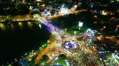 Aerial view of Da Lat city night beautiful tourism destination in central highlands Vietnam. Urban development texture, green parks and city lake.