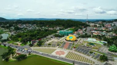 Da lat, Vietnam - July 8th, 2022: Aerial view of Sunflower Building at Lam Vien Square with square, supermarket, park below. Tourist city developed in Da Lat, Vietnam.