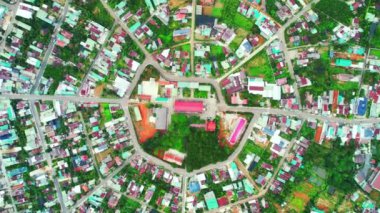 Residential area in Bao Loc city, Vietnam seen from above with the center being the church and the streets divided like abstract Chinese bagua