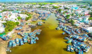 La Gi fishing village seen from above with hundreds of boats anchored along both sides of river to avoid storms near estuary, this is also a large fishing port providing seafood in central Vietnam clipart
