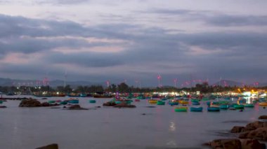 Time lapse sunset on the fishing boat wharf waiting for the day to go to the sea to catch fish and bring income to the fishermen