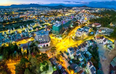 Aerial view of Da Lat city night beautiful tourism destination in central highlands Vietnam. Urban development texture, green parks and city lake.