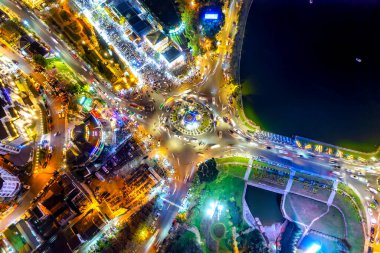 Aerial view of Da Lat city night beautiful tourism destination in central highlands Vietnam. Urban development texture, green parks and city lake.