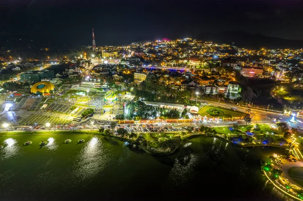 stock image Aerial panorama view of Sunflower Building at night in Da Lat City. Tourist city in developed Vietnam. Center Square of Da Lat city with Xuan Huong lake.