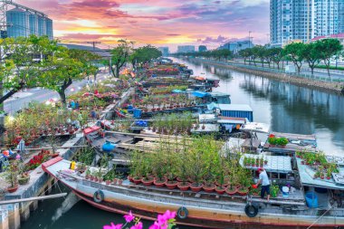 Ho Chi Minh City, Vietnam - 18 Ocak 2023: kanal iskelesi boyunca pazarda çiçek teknesi. Çiftçiler, Ho Chi Minh, Vietnam 'daki Ay Yeni Yılı' nda kayısı çiçeği ve diğer çiçekleri satıyor.