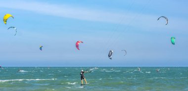 Mui Ne, Vietnam - 11 Şubat 2023: uçurtma sörfü. Mui Ne Körfezi 'nde birçok uçurtma silueti var ve her türlü gösteriyi yapıyorlar. Spor, sağlık, eğlence kavramı. Doğada tatiller