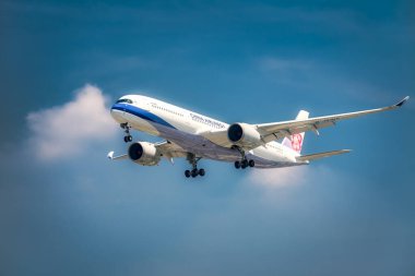 Ho Chi Minh City, Vietnam - March 3rd, 2022: Passenger airplane bearing number B-18915 Airbus A350 of China Airlines landing at Tan Son Nhat International Airport, Ho Chi Minh City, Vietnam clipart