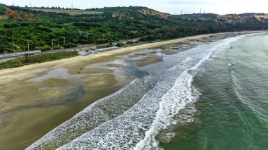 The waves crashing on the golden sand are so beautiful from above, the beach is for relaxing and bathing