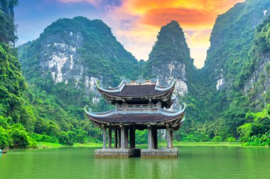 Landscape of Vu Cung at Tam Coc National Park. It was the place where the Tran Dynasty's struggle against the Nguyen Mong army took place and was also the practice place for feudal kings in Vietnam. clipart