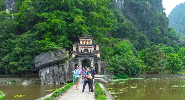 stock image Ninh Binh, Vietnam - April 5th, 2024: Tourists visit the ancient Bich Dong pagoda complex. Ninh Binh, Vietnam travel destination