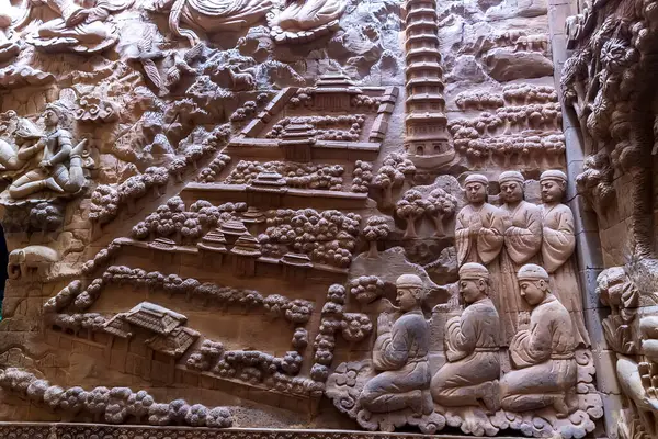 stock image Ninh Binh, Vietnam - April 5th, 2024: Stone carved base-relief of Ky Lan temple. Human figures and floral ornament bas-relief. Traditional Champa architectural details.
