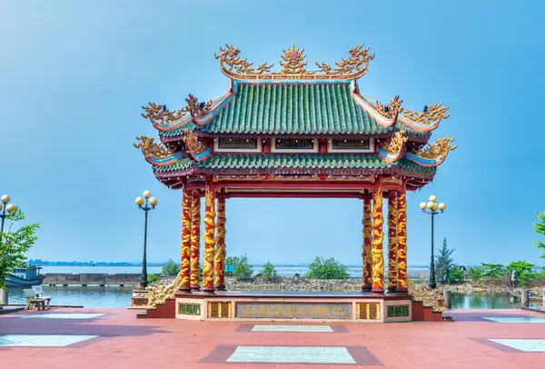 stock image Hue, Vietnam - April 10th, 2024: The communal house with elaborate carved columns of pottery is a typical culture in Ke Vo cultural village, Hue, Vietnam.