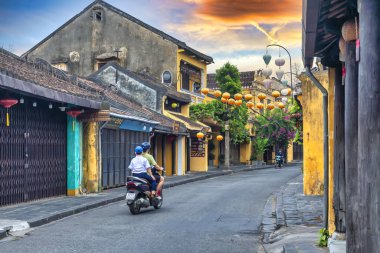Hoi An, Vietnam - 16 Nisan 2024: Trajik, süslü ipek fenerlerin olduğu manzara sabahı, inanılmaz geleneksel sarı evler. Tarihi eski Hoi An kasabası 1999 yılından bu yana UNESCO 'nun Dünya Mirası Alanında yer alıyor.. 