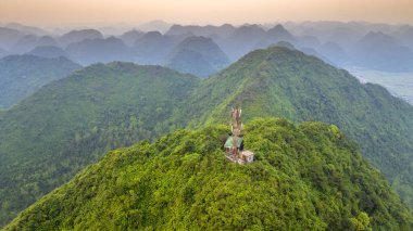 Dağların büyülü manzarası birbirini takip eden mesajı andırıyor. Şafak vakti Bac Son Bölgesi Lang Son, Vietnam 'da yemyeşil bitki örtüsü tabakaları ile kaplandılar.