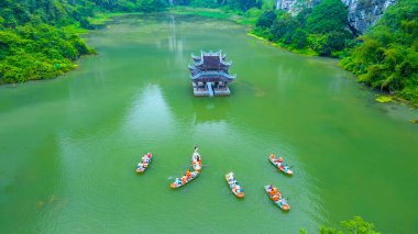 Landscape of Vu Cung at Tam Coc National Park. It was the place where the Tran Dynasty's struggle against the Nguyen Mong army took place and was also the practice place for feudal kings in Vietnam. clipart