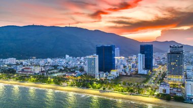 Quy Nhon, Vietnam - April 18th, 2024: The coastal city of Quy Nhon seen from above in the afternoon with its beautiful city and clean sandy beach attracts tourists to visit in Quy Nhon, Vietnam clipart