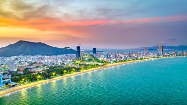 Quy Nhon, Vietnam - April 18th, 2024: The coastal city of Quy Nhon seen from above in the afternoon with its beautiful city and clean sandy beach attracts tourists to visit in Quy Nhon, Vietnam clipart