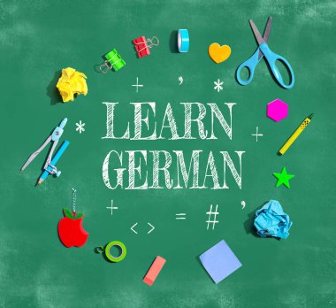 Learn German theme with school supplies on a chalkboard - flat lay