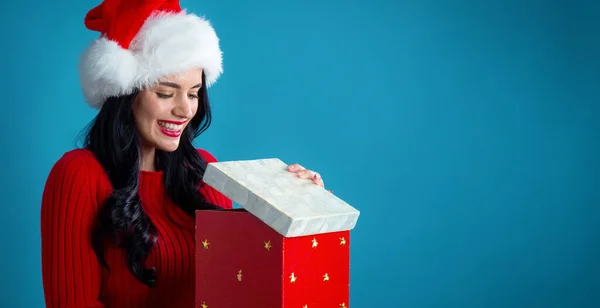 Young Woman Santa Hat Opening Christmas Gift Box Dark Blue — Stock Photo, Image
