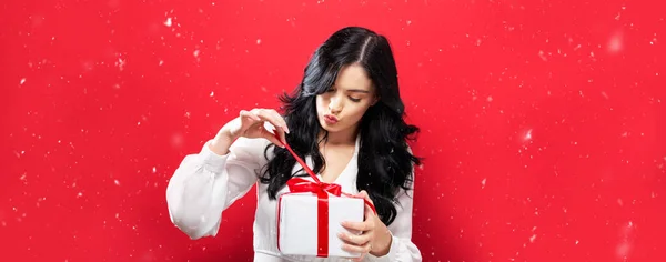 Happy Young Woman Opening Christmas Gift Box Red Background — Stock Photo, Image