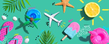 Summer concept with a airplane, a popsicle, flip flops and lemon sunshine - flat lay