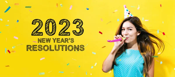 2023 New Years Resolutions with young woman with party theme on a yellow background