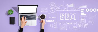 SEM - Search Engine Marketing theme with person using a laptop computer