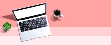 Yukarıdan kahve fincanı olan bir dizüstü bilgisayar.