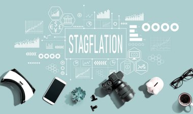 Stagflation theme with electronic gadgets and office supplies - flat lay