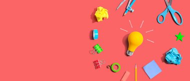 Idea light bulb with school supplies overhead view - flat lay