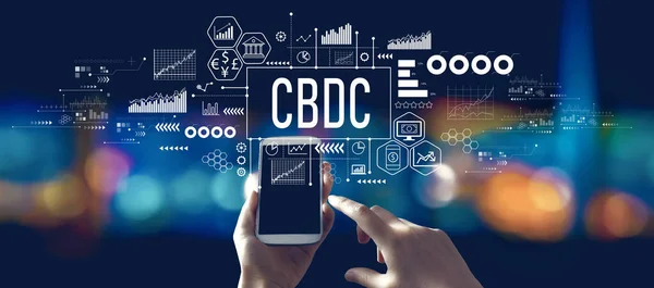 stock image CBDC - Central Bank Digital Currency Concept with person using a smartphone in a city at night