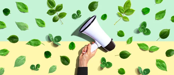 Person Holding Megaphone Green Leaves Flat Lay — Stock Photo, Image