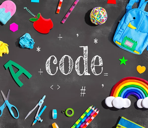 Learn to Code theme with school supplies on a chalkboard - flat lay