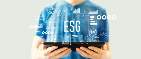 Stock image ESG - Environmental, Social and Governance concept with young man using a tablet computer