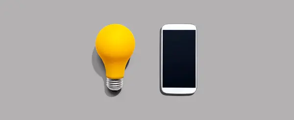Smartphone Yellow Light Bulb — Stock Photo, Image