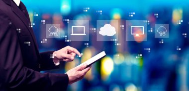 Cloud computing with businessman using a tablet computer at night