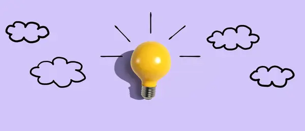 Yellow light bulb with cloud sketches - Flat lay